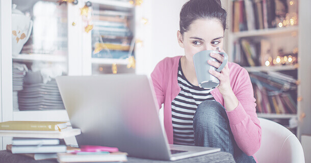 A woman sitting at a table using a laptop