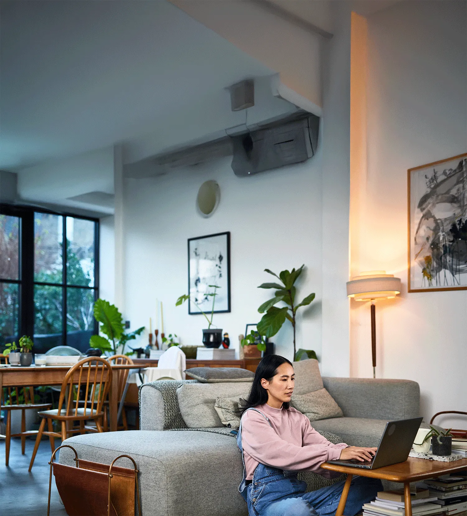 Woman relaxing at home while checking her credit score on a laptop